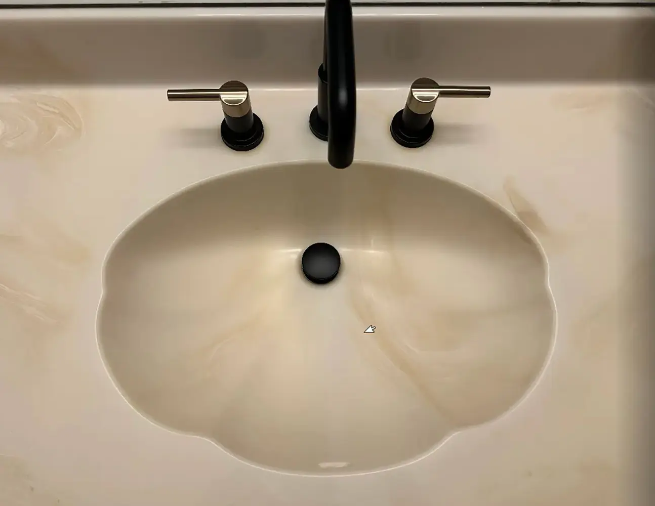 Modern widespread bathroom faucet installed on a vessel sink with matte black spout, dual handles, and a contemporary vanity countertop.
