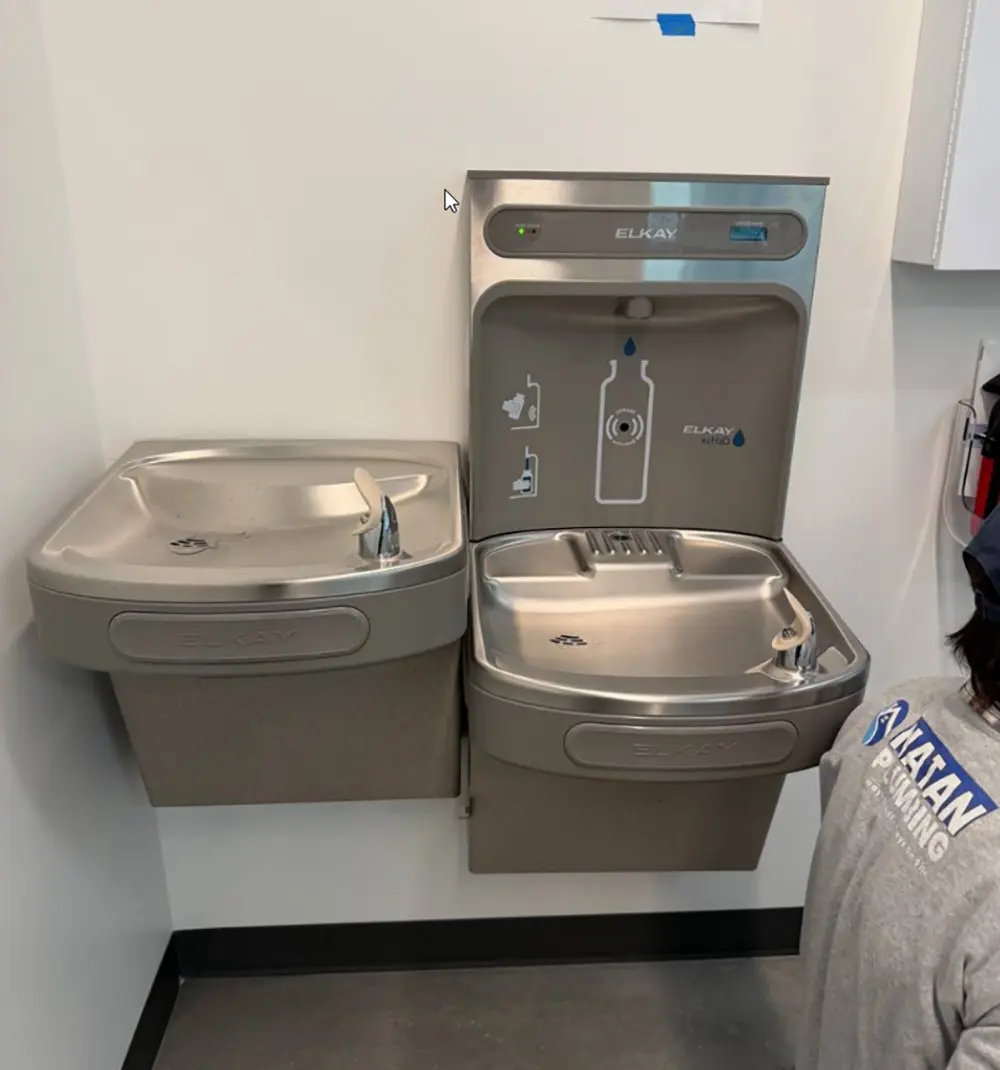 Elkay bottle filling station and drinking fountain with new water filter cartridge installed, tested, reset, and ready for reliable filtered drinking water.